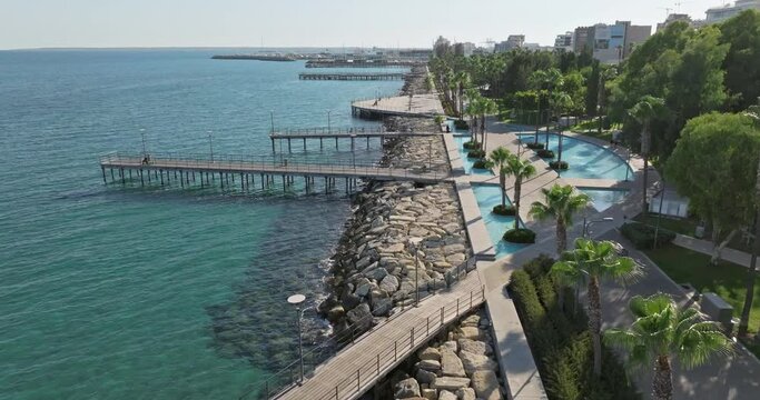 Aerial view of the Limassol embankment, Cyprus. Modern architecture of the park and alleys for walks on the seashore. High quality 4k footage