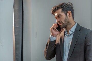 handsome businessman with beard casual suit talk conversation to manager by smart mobile phone....