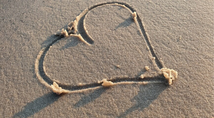 Fototapeta na wymiar Drawn heart on the sand. Heart drawing vector. Honeymoon trip. Beautiful heart declaration of love. Symbol of love. Romance and love background. Valentine's day, wedding, engagement.