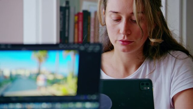 Tired woman designer working on tablet pc with pen at home