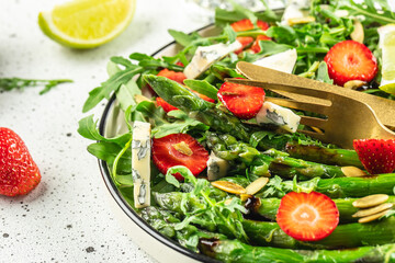 Healthy Green Salad Leaves, Slices of Fresh Strawberries. Concept healthy and balanced eating. place for text, top view
