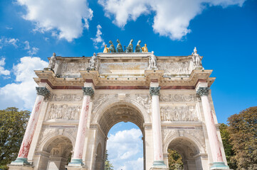 Fototapeta na wymiar View of the Arc de Triomphe du Carrousel, a triumphal arch in Paris, located in the Place du Carrousel, France
