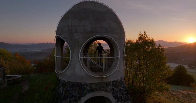 Hiker enjoys sunrise Bohemian Switzerland in Czech Republic Tower Ruzenka Aerial