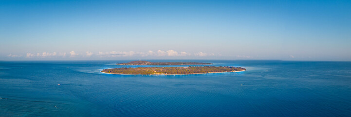 Fototapeta na wymiar Tropical island in the blue ocean, Gili Travangan Lombok Indonesia, Panoramic aerial drone