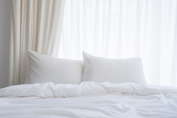 Minimal white pillow with nature light from curtian windows.