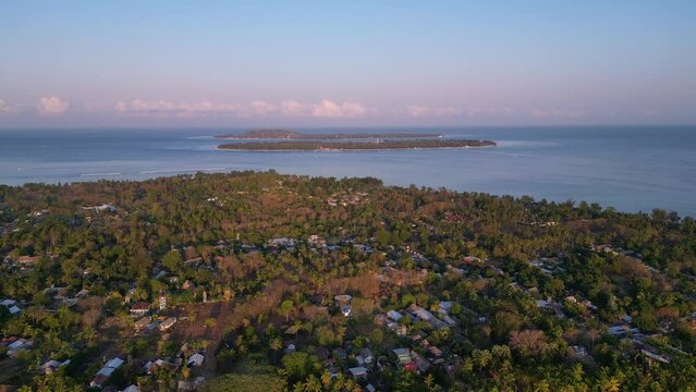 Aerial drone footage of Gili Travangan Island in the ocean, Tropical Island Indonesia
