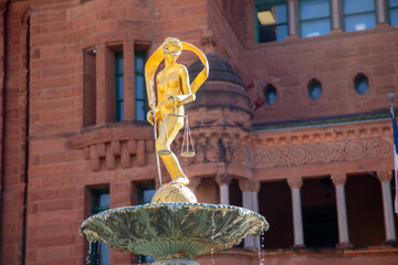 Lady Justice Statue on Water Fountain with San Antonio Downtown Building in Background