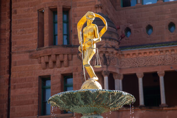Lady Justice Statue on Water Fountain with San Antonio Downtown Building in Background