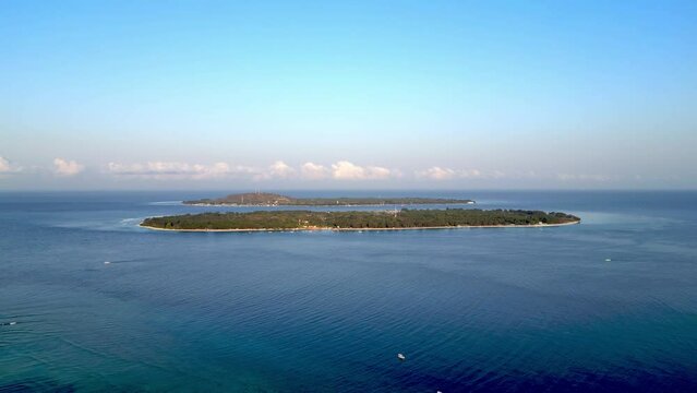 Aerial drone footage of Gili Travangan Island in the ocean, Tropical Island Indonesia