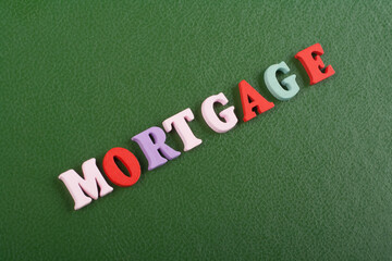 MORTGAGE word on green background composed from colorful abc alphabet block wooden letters, copy space for ad text. Learning english concept.