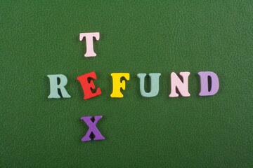 TEX REFUND word on green background composed from colorful abc alphabet block wooden letters, copy space for ad text. Learning english concept.