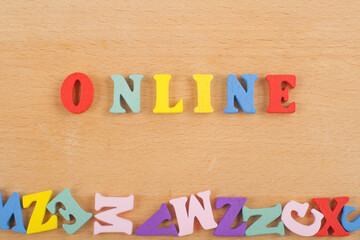 ONLINE word on wooden background composed from colorful abc alphabet block wooden letters, copy space for ad text. Learning english concept.