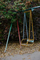 Children's swing for one person. Retro playground. Yard equipment in CIS countries during the...