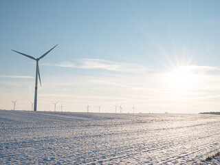 Wind turbines and agricultural field on winter day.