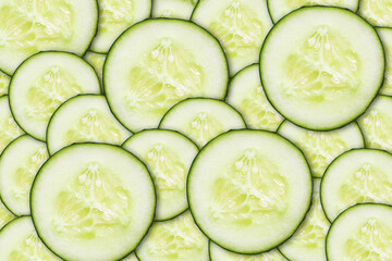 Cucumber slices pattern. Pile of round cucumber cuts texture. Green vegetable background. Cucumber...