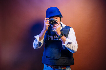Reporter in bulletproof vest with a camera.
