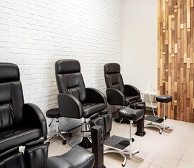 A black pedicure chair in a beauty salon.