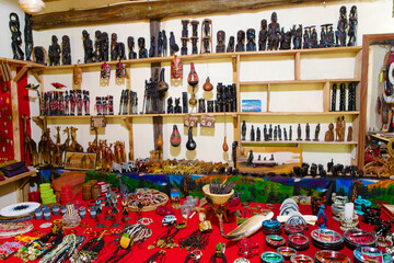 gift shop for tourists with masks and figures - obrazy, fototapety, plakaty