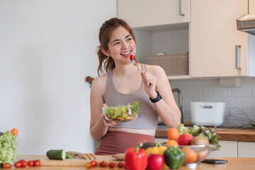 Sporty young woman is preparing healthy food on light kitchen. healthy food concept.