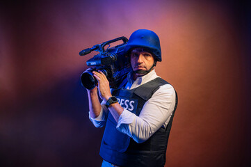 Reporter in bulletproof vest holding a video camera