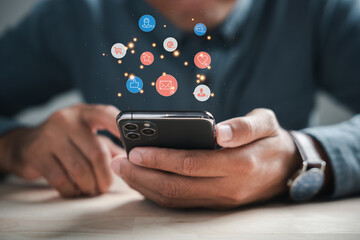 Digital connectivity at home man chats on smartphone, discussing live chat social network concepts. Icons appear in chat box, portraying modern communications role. Social media marketing technology