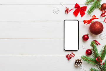 Digital phone mock up with rustic Christmas decorations for app presentation top view with empty...