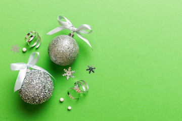 Christmas ball on colored background. decoration bauble with ribbon bow with copy space