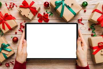 Christmas online shopping from home, female hands holding tablet pc with blank white display top...