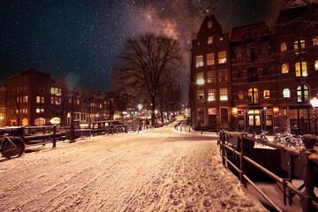 Snowy Amsterdam by night in the Netherlands