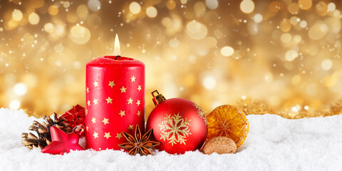 Christmas card advent time with burning candle decoration panorama golden background with copyspace...