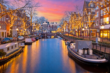City scenic from Amsterdam at christmas time in the Netherlands at sunset - obrazy, fototapety, plakaty