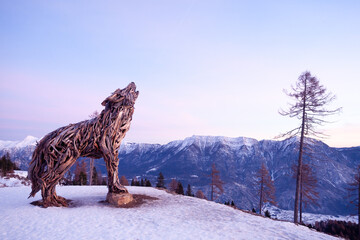 Wooden sculpture of a wolf. Italian landmark at dawn