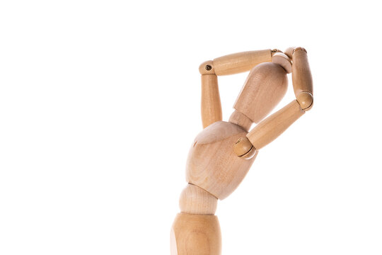 A wooden mannequin holding a tennis racket. Suitable for sports-related projects or design concepts.