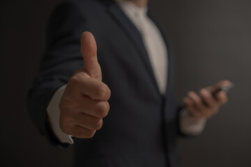 business man giving thumbs up for react other for doing a good work , working well , successful 