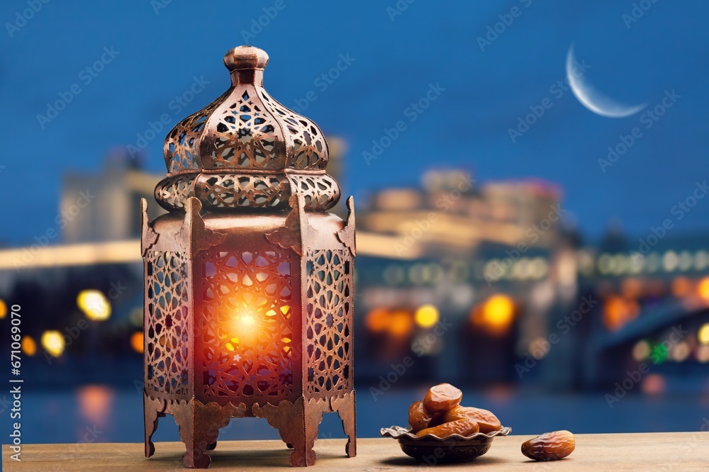 Wall mural Ornamental beautiful Arabic lantern glowing at night.