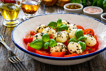 Caprese salad on wooden background
