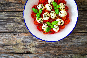 Caprese salad on wooden background
