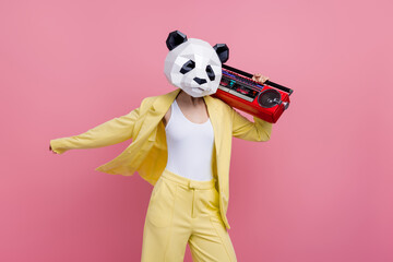 Portrait of cool funky 3d panda mask lady dancing carry boombox rejoice isolated on pink color background © deagreez