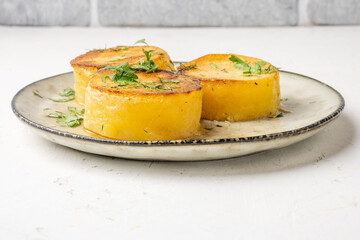 Potato fondant, melted potatoes close-up, sprinkled with herbs.