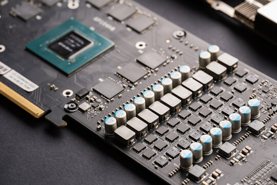 Electronic components and video card microchips. Close-up of an electronic board with SMD components. Latest generation video card. Resistors, capacitors, transistors, crystal oscillator, inductor.