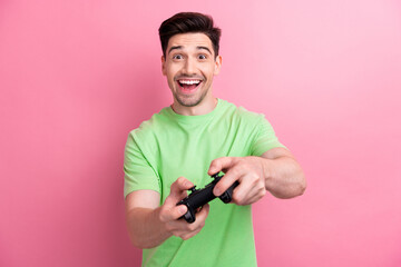 Photo of young addicted gamer brunet hair guy playing video game using wireless connection gamepad...