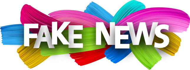 Fake news paper word sign with colorful spectrum paint brush strokes over white.