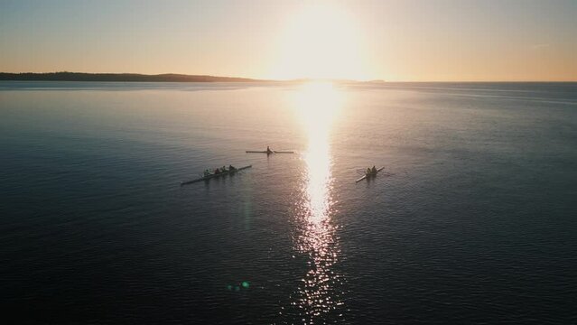 Aerial view Beautiful Sunrise in the Sea on Rowing Boat.