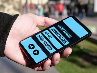 Male hand with smartphone for personal financial transaction on mobile banking app. Account balance, pay bill and money transfer. Online banking and internet banking concept