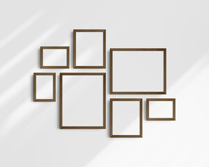 Gallery wall mockup set, 7 dark brown walnut wood frames. Modern frame mockup. Horizontal, vertical frames, 5x7 (5:7), 7x5 (7:5), 8x10 (4:5), 12x15 (4:5), 15x12 (5:4) inches. White wall with shadows.