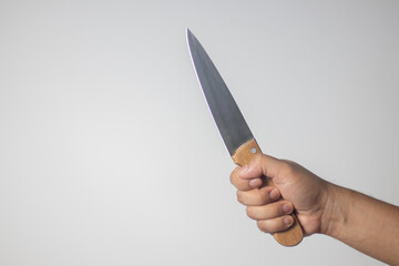 Male hand holding a knife on white background