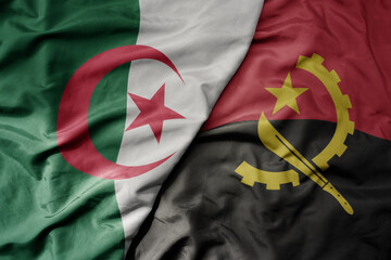 big waving national colorful flag of algeria and national flag of angola .