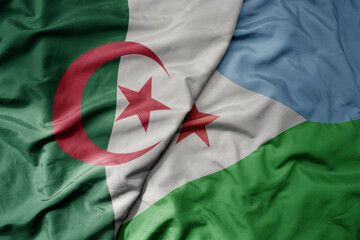 big waving national colorful flag of algeria and national flag of djibouti .