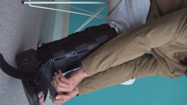 Young man with leg injury using Splint, walker boot, Orthosis, sprained ankle