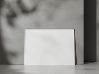 Blank poster with frame mockup on grey wall with shadow